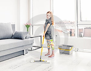 Little girl cleaning floor