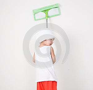 Little girl cleaning with a mop.