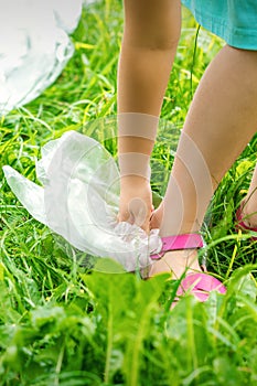 Little girl cleans plastic bags