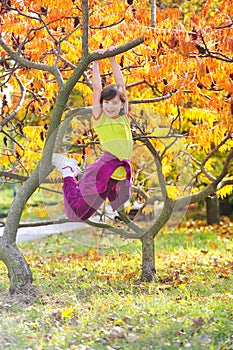 Little girl climbed on tree