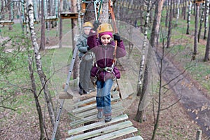 Little girl climber start the passage ropes course