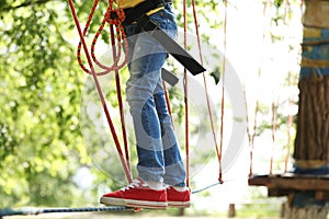 Little girl climbing in adventure park