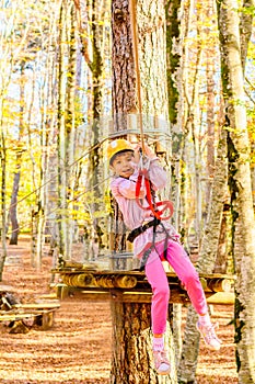 Little girl climbing in adventure park