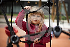 Little girl climbing rope ladder