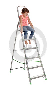 Little girl climbing up ladder on white . Danger at home