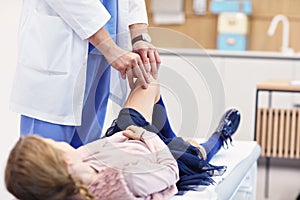 Little girl in clinic having a checkup with orthopaedist