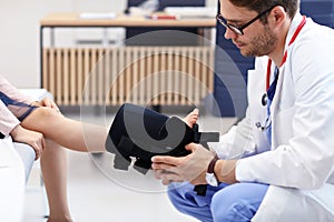 Little girl in clinic having a checkup with orthopaedist photo