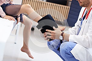 Little girl in clinic having a checkup with orthopaedist