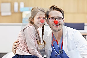 Little girl in clinic having a checkup with pediatrician