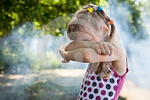 Little girl closed eyes her arms