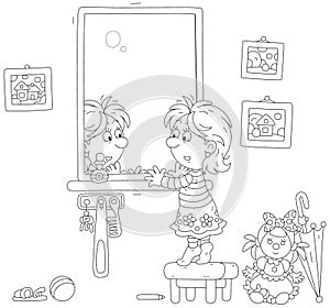 Little girl closely looking in the mirror