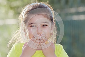 Little girl closing mouth