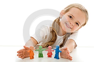 Little girl with colored clay figurines