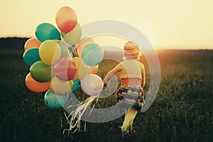 Little girl with colorful balloons