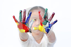 Little girl with colorful hands painted isolated on white background. Focus at child hands
