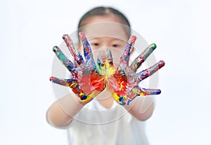 Little girl with colorful hands painted isolated on white background. Focus at child hands