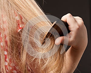 Little girl combing her beautiful long hair