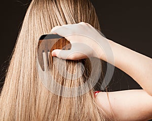 Little girl combing her beautiful long hair