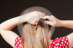 Little girl combing her beautiful long hair