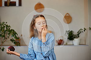 Little girl comparing food, choosing microgreen against sweet cake, Healthy dieting habit