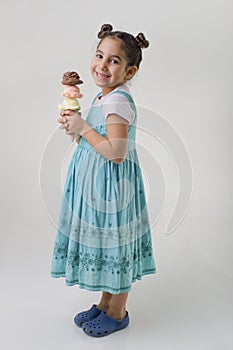 Little girl a cone with three ice cream flavors