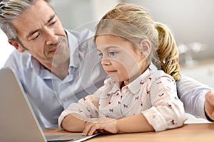 Little girl connected on laptop