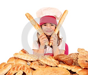 Little girl cook with buns and pretzel