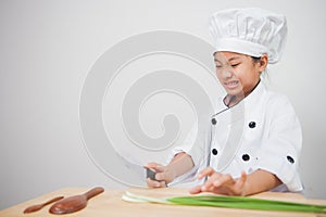 Little girl cook,children chef afraid of vegetables