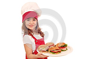 Little girl cook with sandwiches
