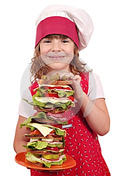 Little girl cook with tall sandwich