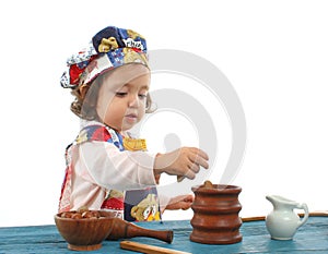 Little girl cooking dressed as a chef