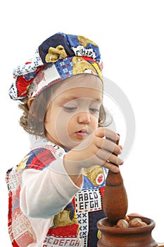 Little girl cooking dressed as a chef