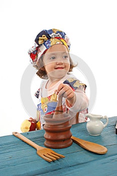 Little girl cooking dressed as a chef