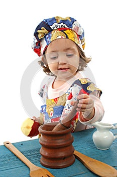 Little girl cooking dressed as a chef