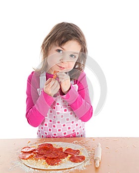 Little girl cooking pizza