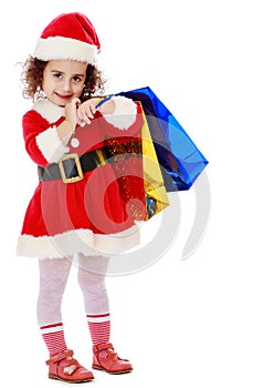 Little girl in costume of Santa Claus with colorful packages