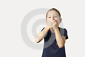 Little girl covering her mouth with her hands