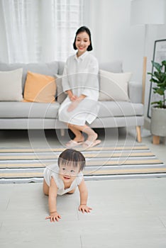 Little girl crawling on the floor in living room