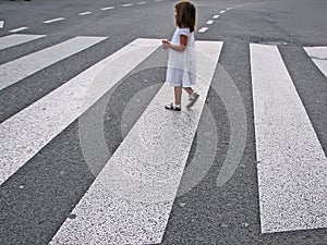 Little girl crossing street