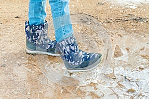 Little Girl crushing ice at outdoor in winter