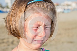 Little girl crying at the beach