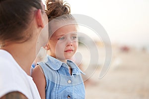 Little girl crying Mother daughter summer beach. Child upset and cry