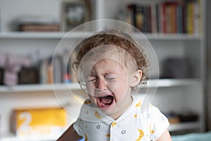 Little girl crying. One year old baby crying at home