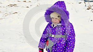 Little girl crying outside in winter. A child in warm clothes is upset, cold. Winter, snow, frost