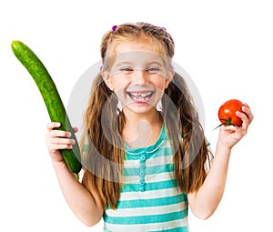 Little girl with cucumber and tomato