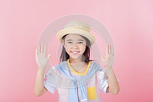little girl cute child posing on on a pink background