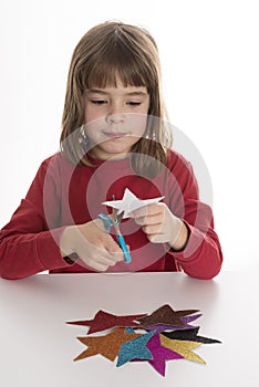 Little girl cutting stars