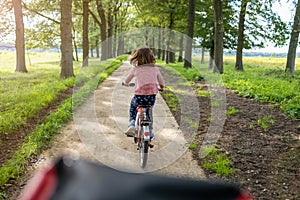 Little girl cycling in the countryside