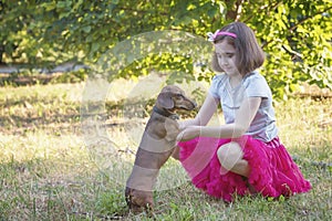 Little girl and dachshund dog