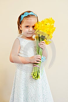 Little girl with   daffodils